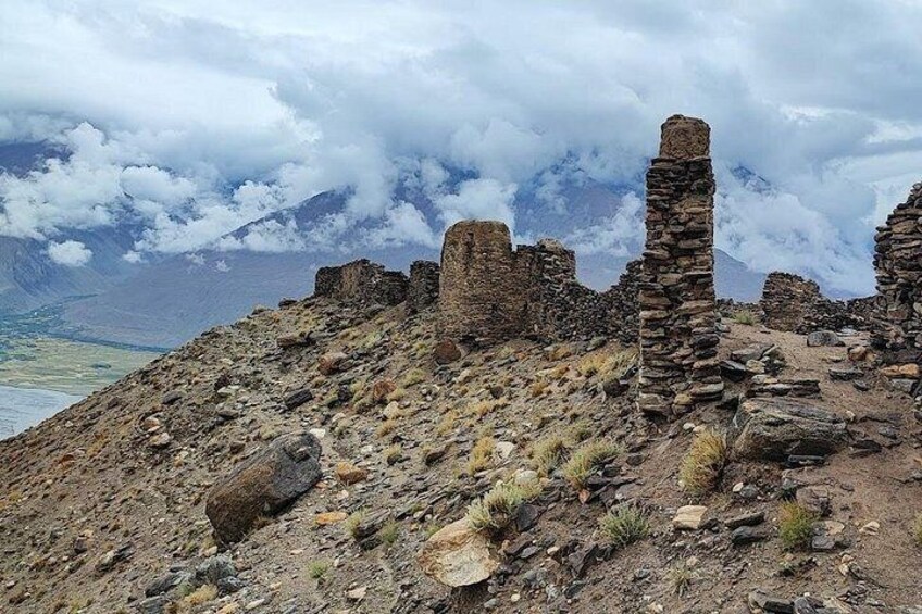 Ancient stone ruins on a mountain with a cloudy sky. 2