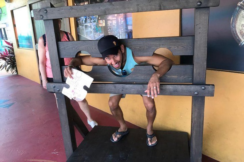 A person performing a pull-up on a wooden bench. 4