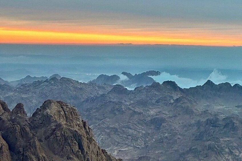 A mountainous landscape with rugged terrain and a sunset sky. 3