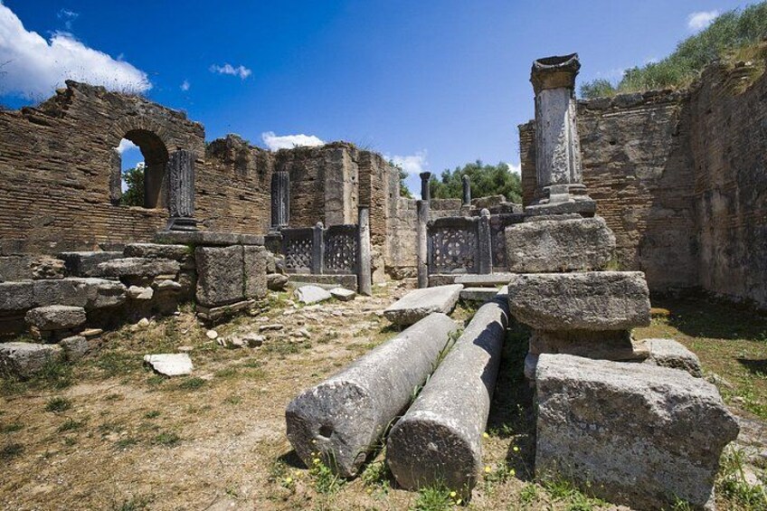 Ancient ruins with stone columns and arches. 4