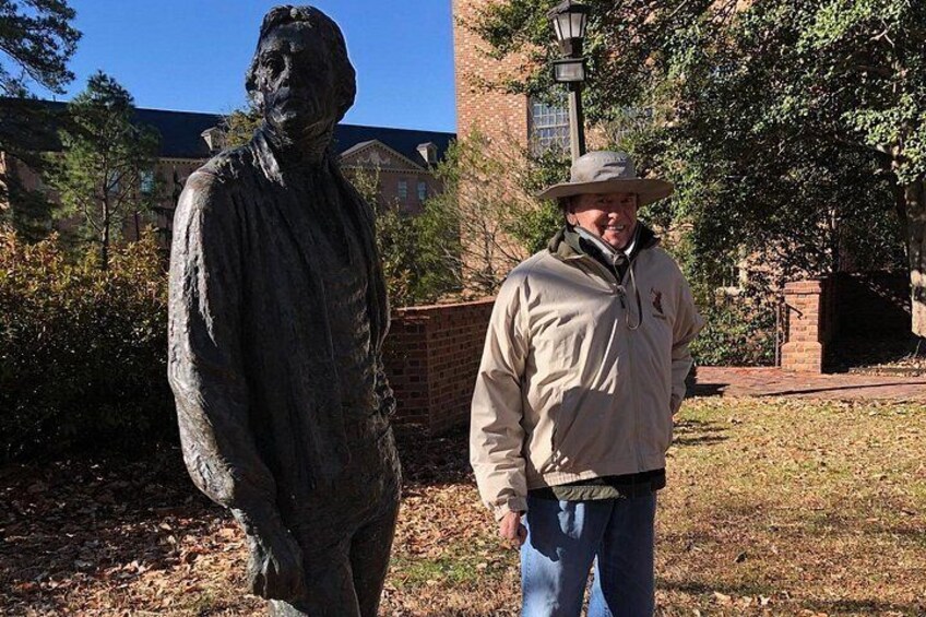 A visitor strikes a pose with Thomas Jefferson's statute 3