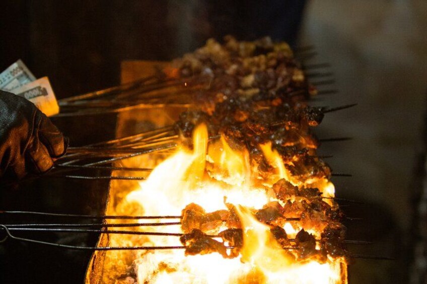 Skewers of meat over an open flame. 5
