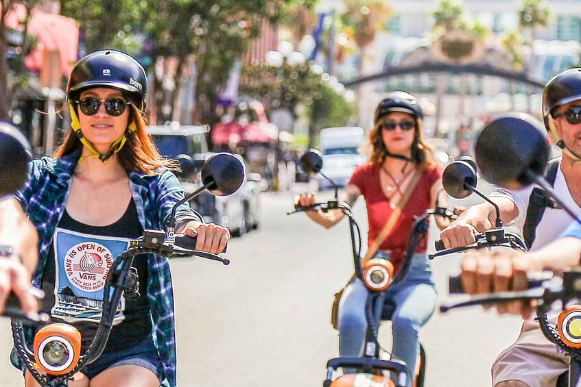 A group of people riding motorcycles on a street. 4