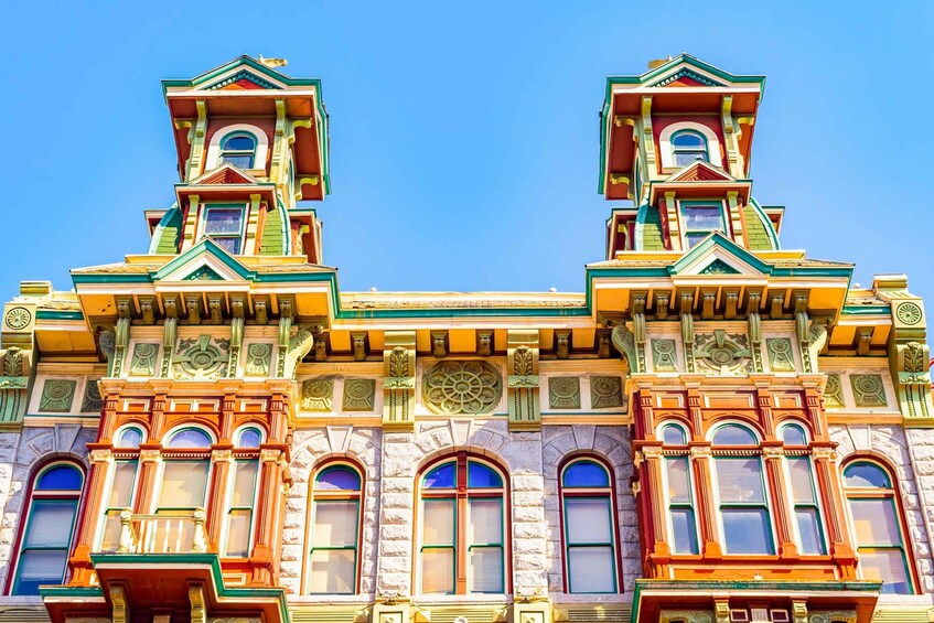 A colorful, ornate building with intricate architectural details and multiple windows. 2