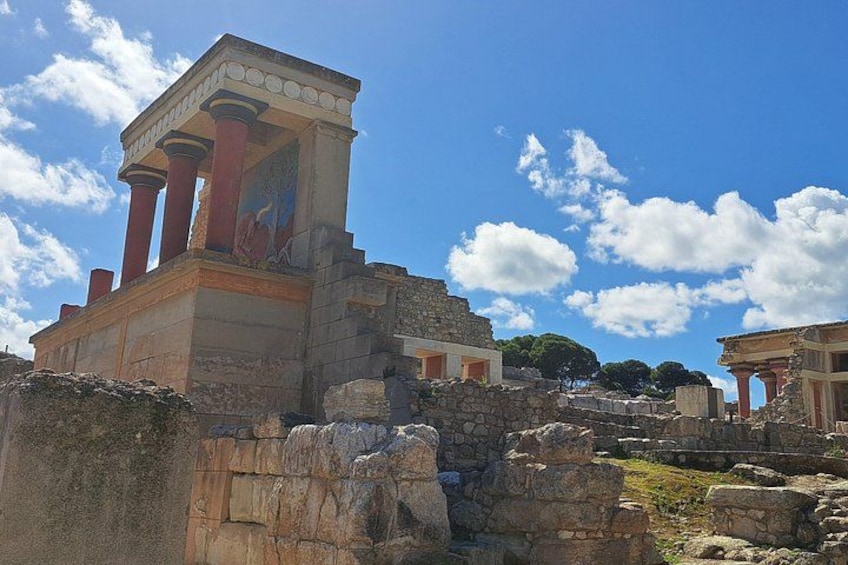 Ancient ruins with columns and a temple-like structure. 2
