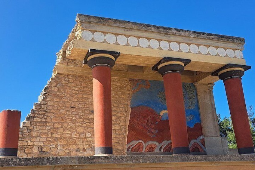 A classical building with red columns and a stone facade. 1