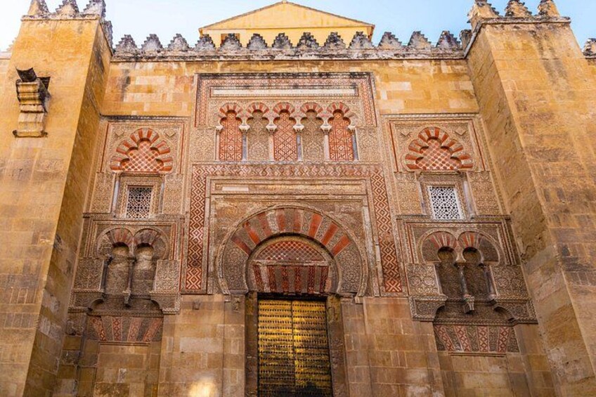 A historic building with intricate arches and detailed stonework. 1
