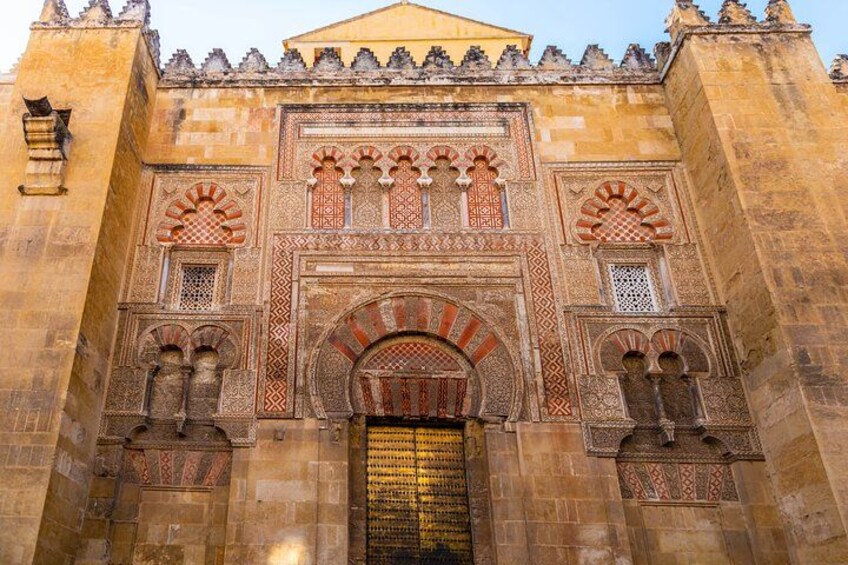 A historic building with intricate arches and detailed stonework. 1