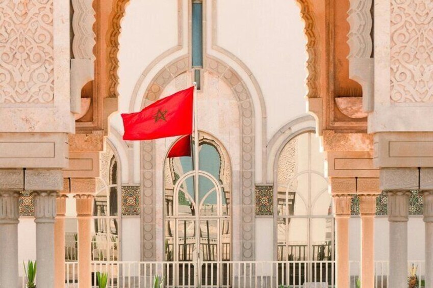 A building with ornate arches and a flag. 5