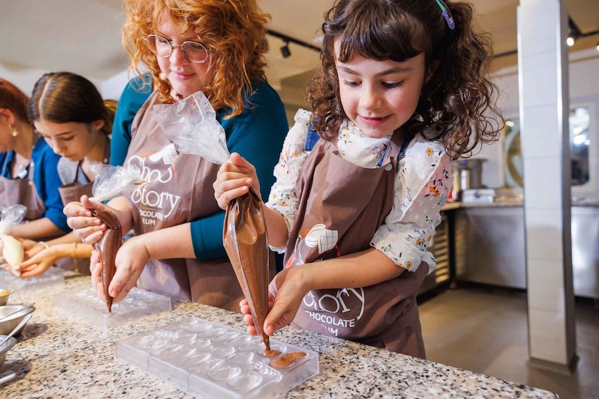 People making chocolate treats in a kitchen. 4