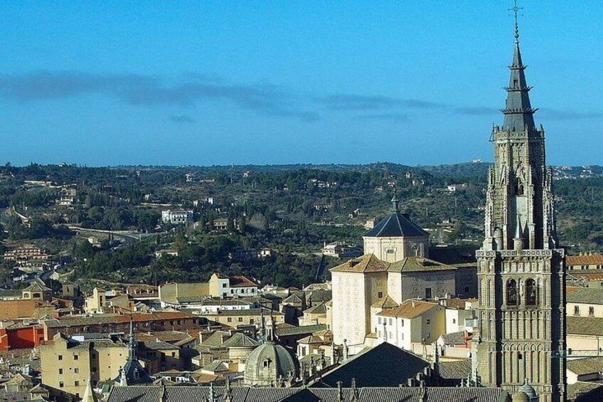 A cityscape with a prominent church tower, a cathedral, and surrounding buildings. 1