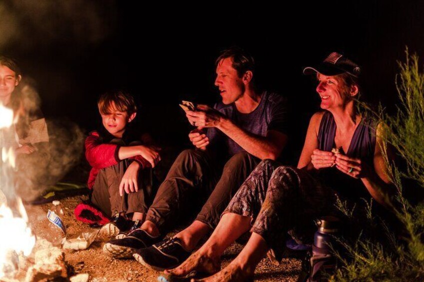 A family on tour enjoying some fresh s'mores.