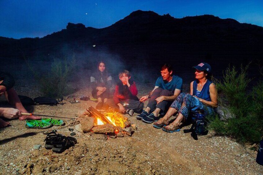 Guests gathering around the bonfire getting ready for s'mores.