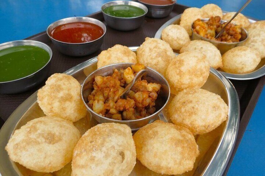 A tray of fried snacks with dipping sauces. 5