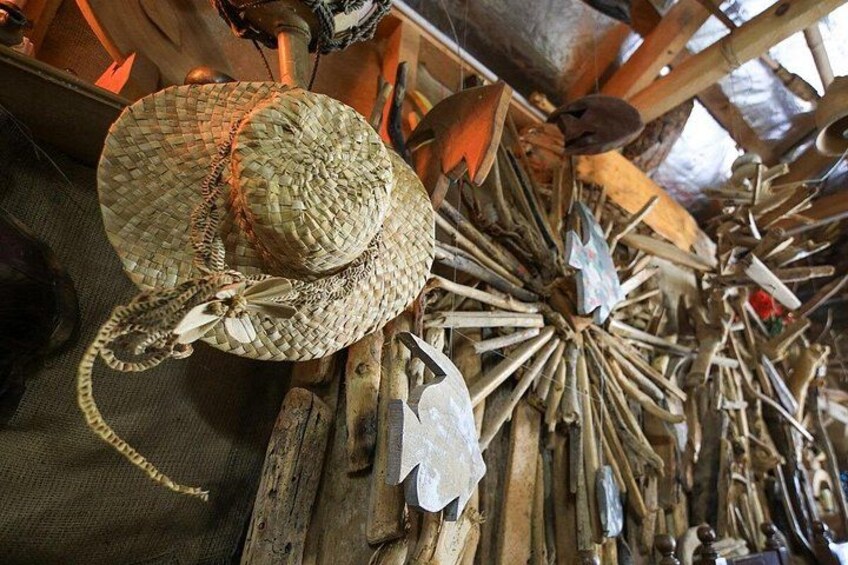 A woven hat with a ribbon and a starburst pattern of sticks. 2