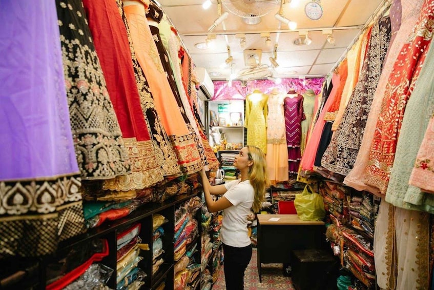 A store with shelves of colorful fabrics and a person browsing. 5