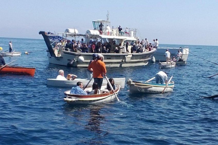 Un groupe de bateaux sur l’eau, avec des personnes à bord. 5