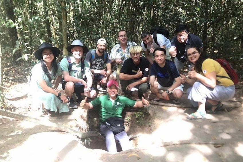 A group of people in a forested area with trees and a dirt path. 3