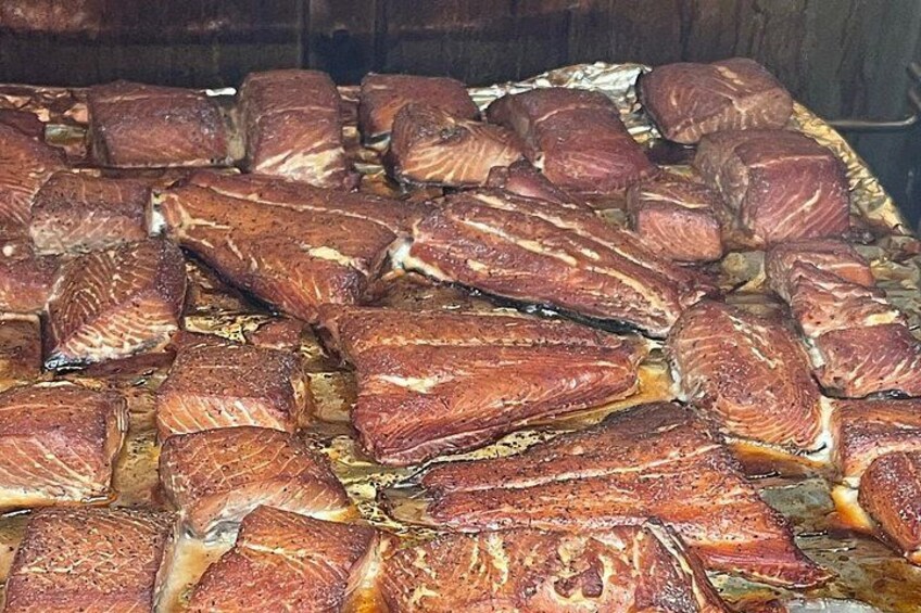 A large quantity of cooked meat, likely pork, arranged in a large tray. 3