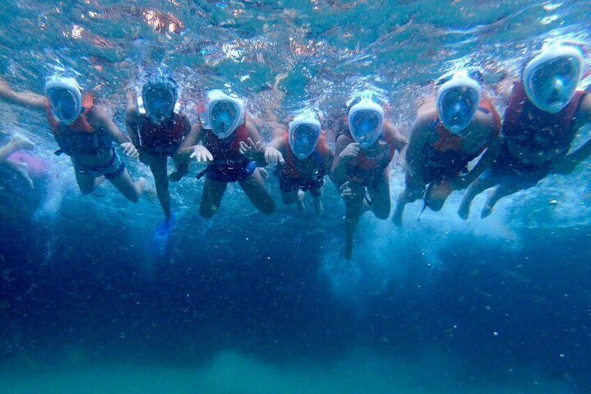 A group of people snorkeling underwater. 3