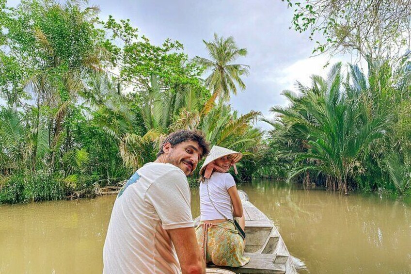 Two people in a boat on a river surrounded by lush greenery. 5