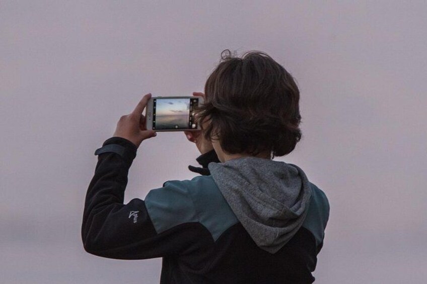 A person taking a photo with a smartphone. 2