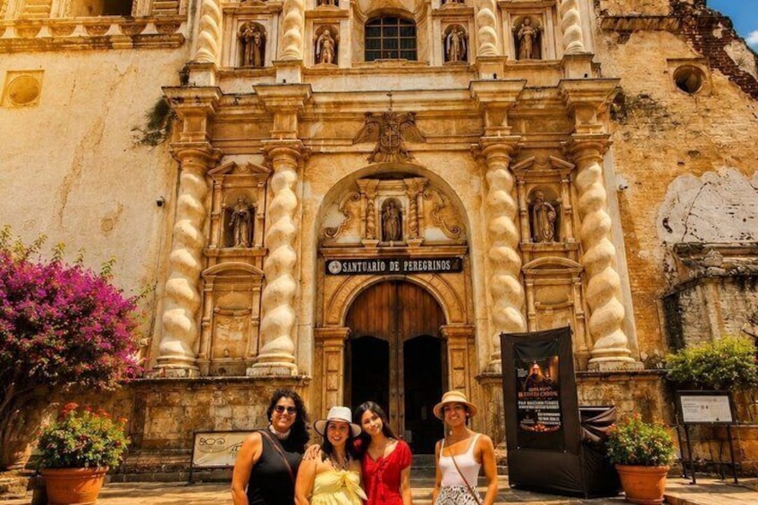 A historic building with ornate architecture, a sign reading 'SANTUARDO DE PEREGRINOS,' and a group of people in front. 2