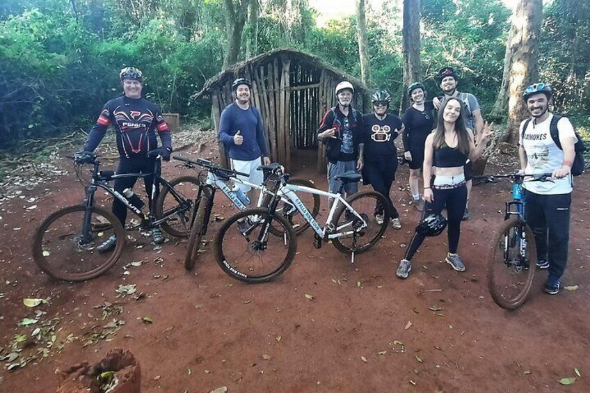 A group of people with bicycles in a forested area. 3