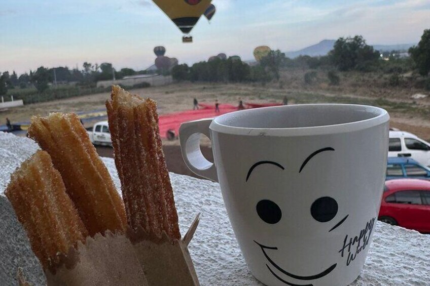 Churros next to a mug with a smiling face. 5