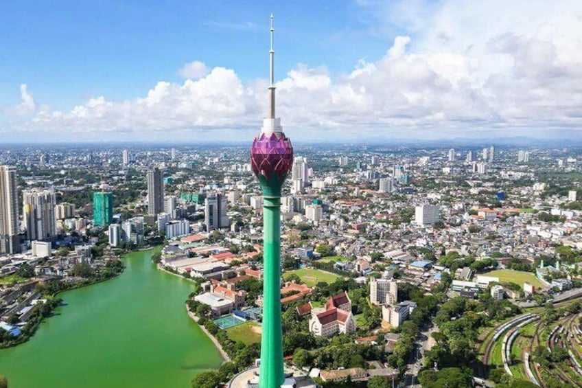 A cityscape with a prominent tower, a river, and surrounding buildings. 2