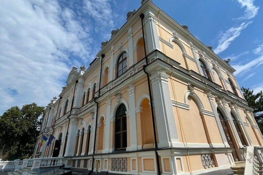 A historic building with classical architecture, featuring arched windows and decorative moldings. 3