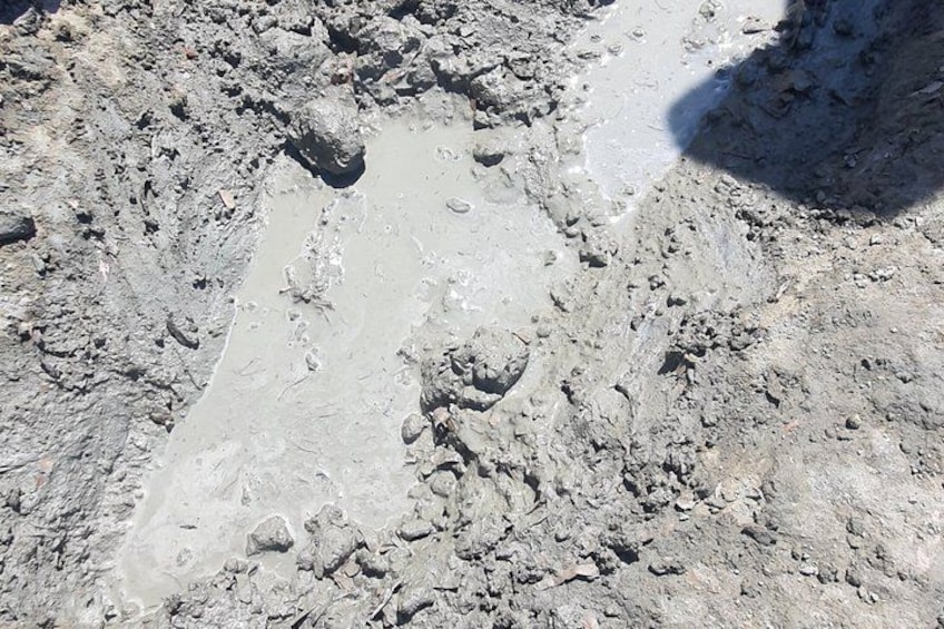 A rocky terrain with visible footprints and a shadow of an object. 2