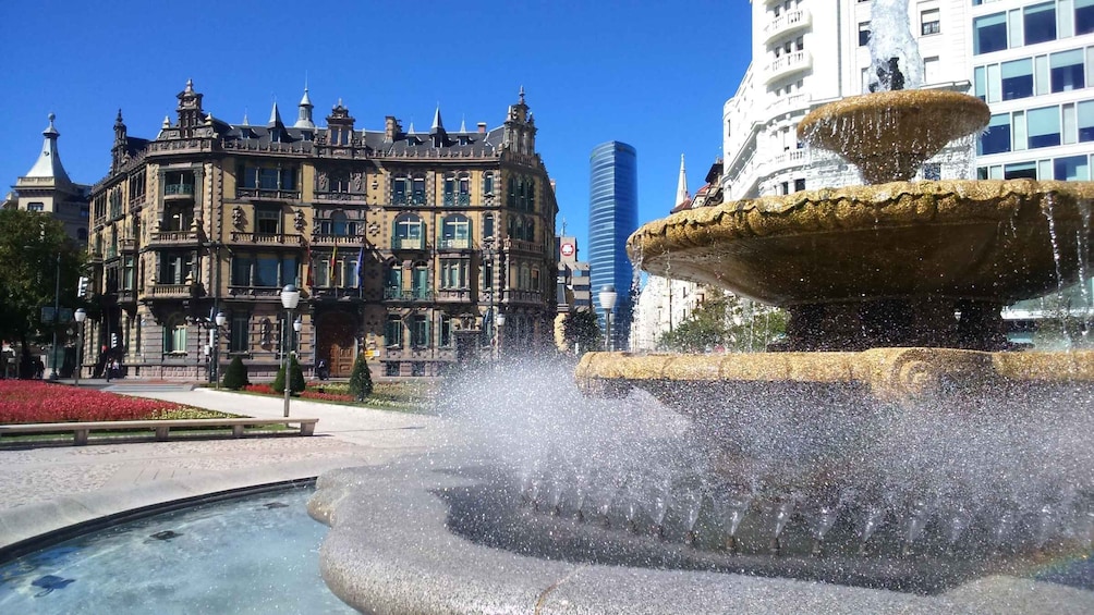 A historic building with ornate architecture and a modern skyscraper in the background. 5
