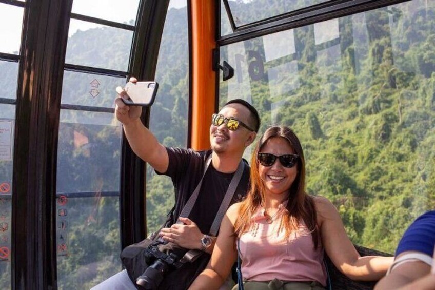 A person taking a selfie with a smartphone in a cable car. 3