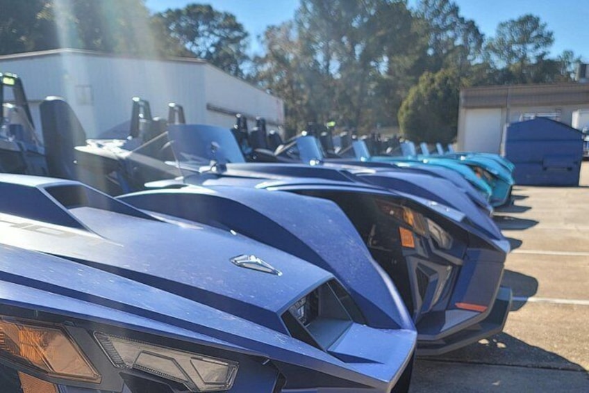 A row of parked vehicles with a distinctive emblem on the front. 2