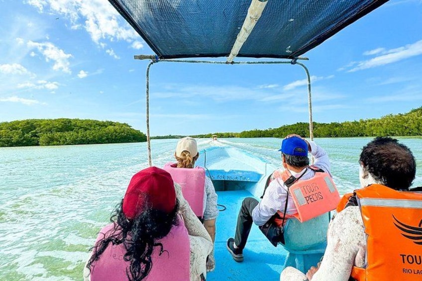 A boat tour with passengers wearing life jackets and a guide. 3