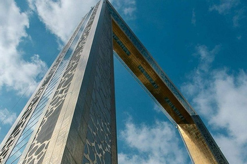 A tall, modern building with a distinctive arch structure. 4