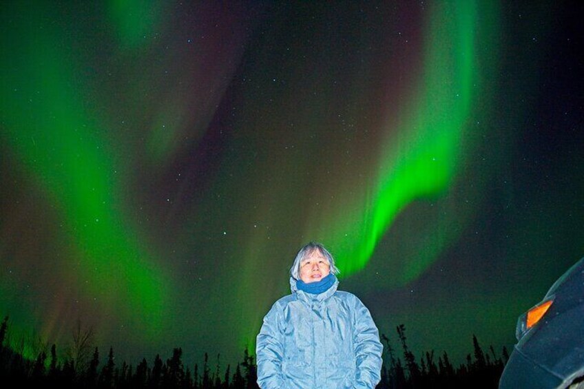 A person standing under the Northern Lights. 4