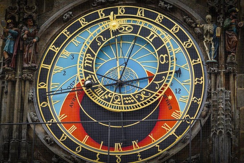 A detailed astronomical clock with zodiac signs and planetary orbits. 2