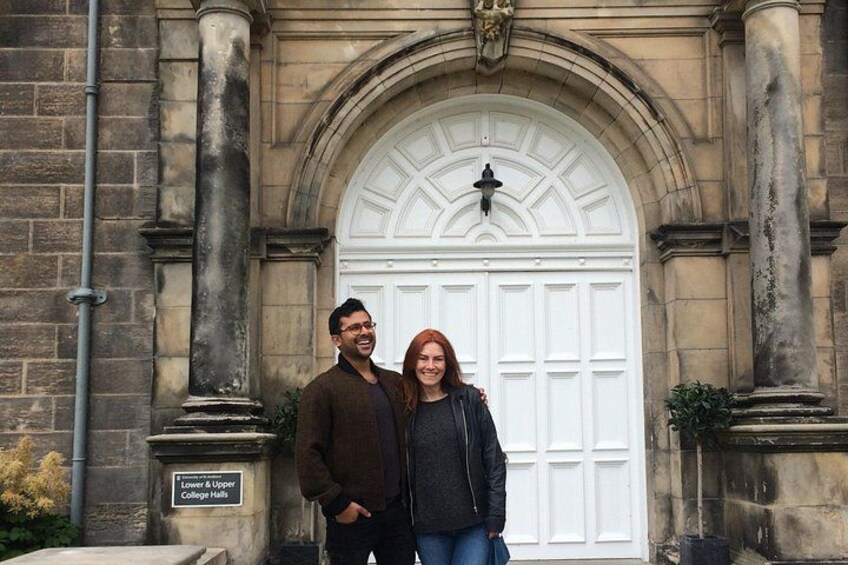 A couple standing in front of a historic building with a white door and columns. 5