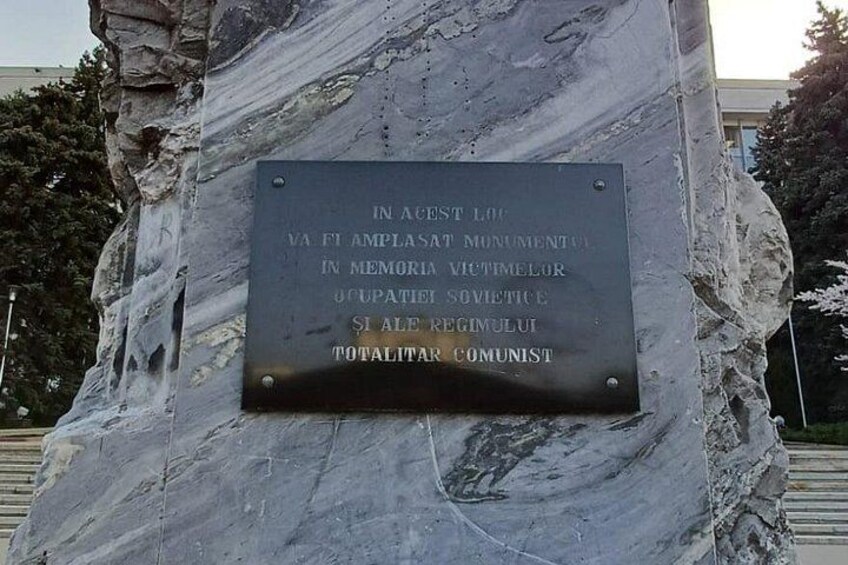 A stone monument with a plaque. 4