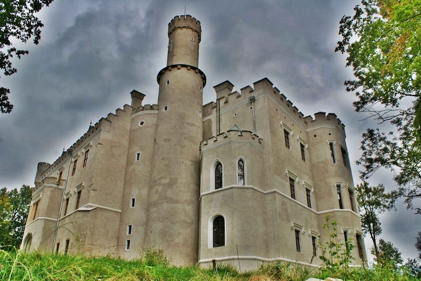 A large, historic castle with multiple towers and arched windows. 5