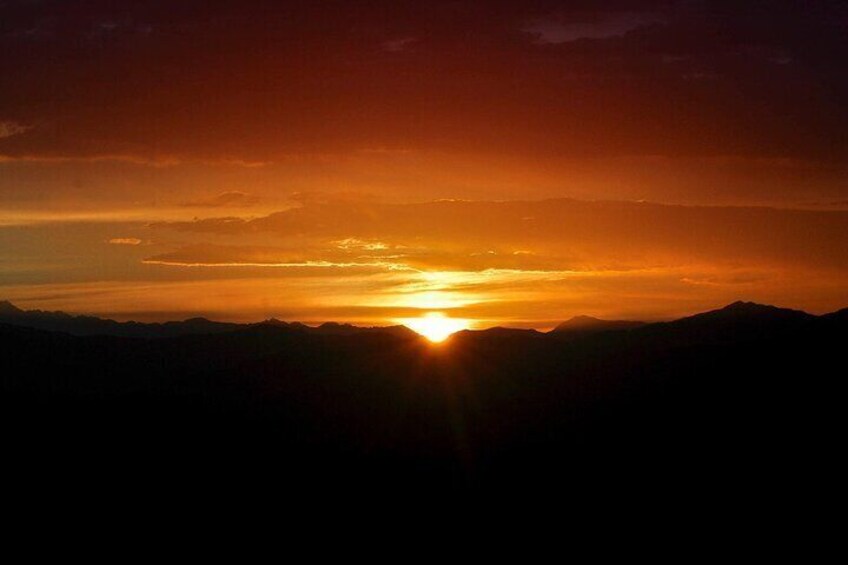 A sunset over a mountainous landscape. 4