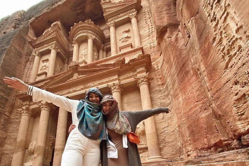 A large carved rock structure with columns and intricate designs. 5