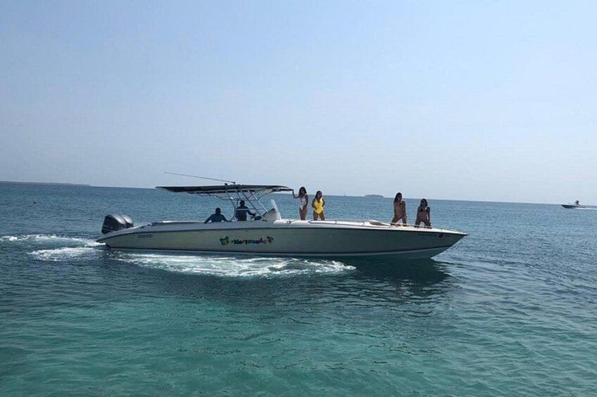 A speedboat with passengers on a calm sea. 4