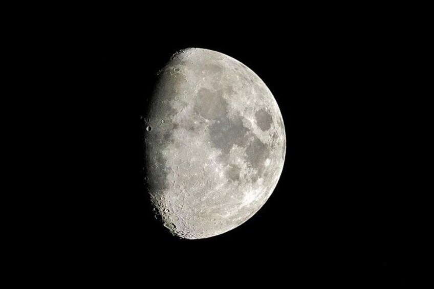 A detailed view of the moon's surface with visible craters and maria. 2