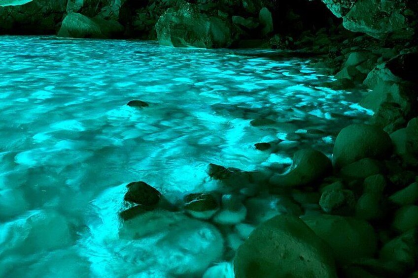 A river with clear water flowing over rocks. 2