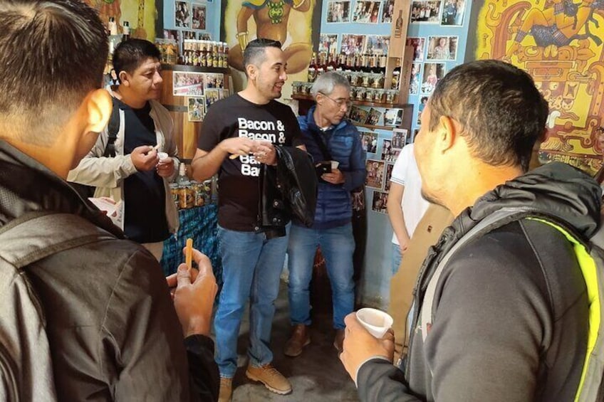 A group of people in a store with shelves of products. 3