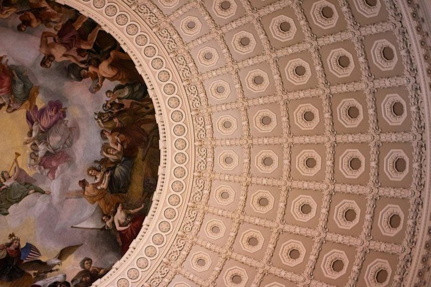 A domed ceiling with a fresco mural and intricate geometric patterns. 2