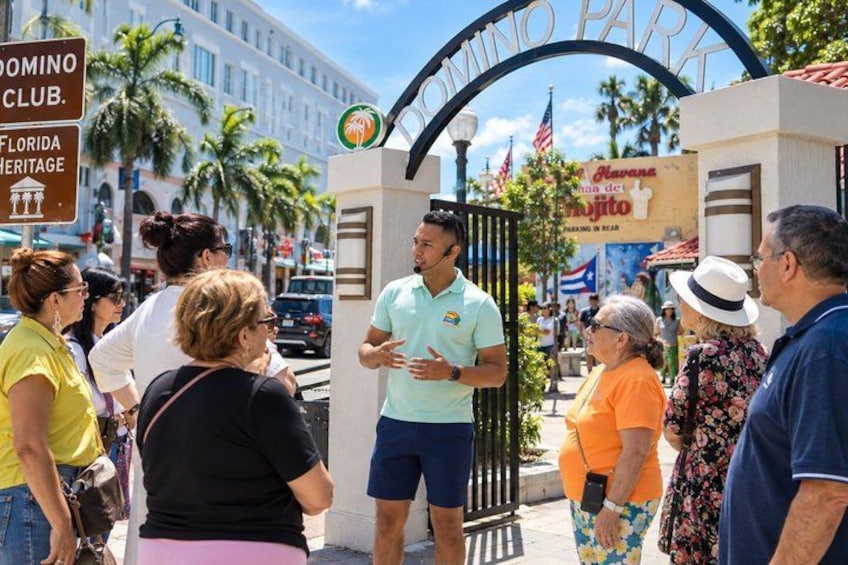 A group of people standing at a gate with a sign that reads 'DOMINO PARK' and 'Havana de la Playa'. 1